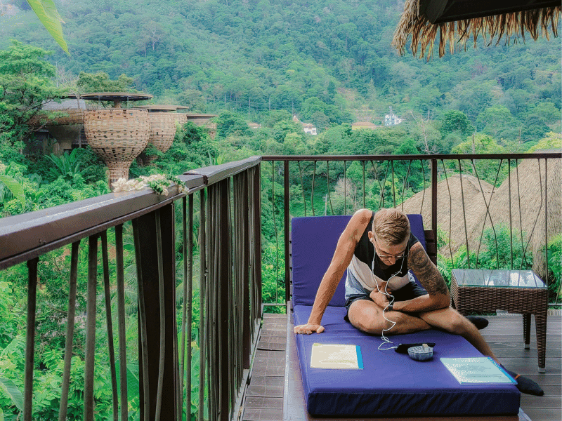 The author sits on the balcony taking a Thai language class with Keemala in the background