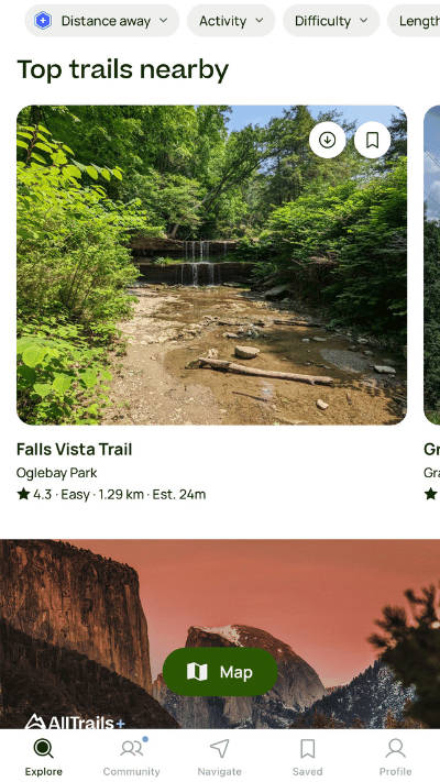 Homepage of AllTrails app showing 'Top trails nearby' with the Falls Vista Trail at Oglebay Park rated 4.3 and marked as easy, with a lush green photo of the trail's waterfall and a scenic dusk photo of a mountain from the app's trail collection.