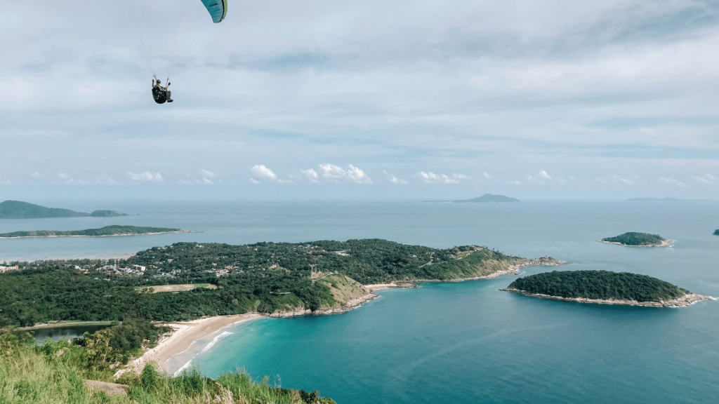 A panoramic view from Black Rock Viewpoint overlooking the turquoise waters of Nai Harn area in Phuket.