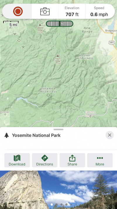A topographic map view in Gaia GPS app highlighting the green terrain of Yosemite National Park, with elevation, speed, and a scenic photo of a rock face from within the park.