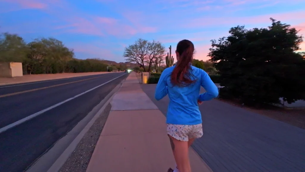 The paved road leading toward the base of the peaks, representing the warm-up miles often included when running Camelback Mountain.