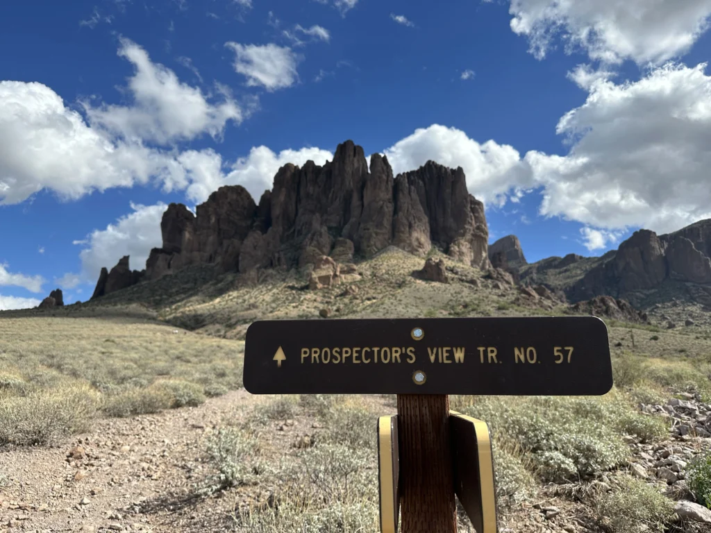 Prospector's View Trail sign with the Superstition Mountains rising behind it in Lost Dutchman State Park